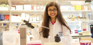 Person smiling with pipette